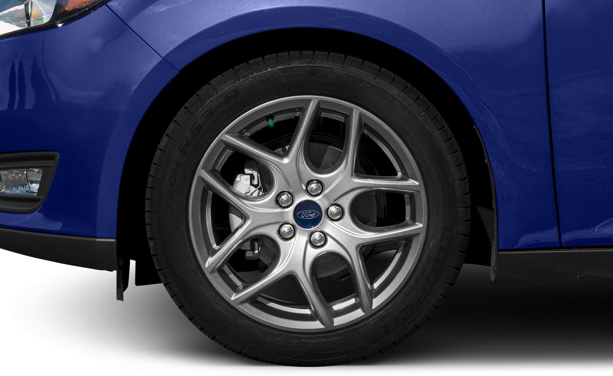Close-up of alloy wheel with tire and blue car body