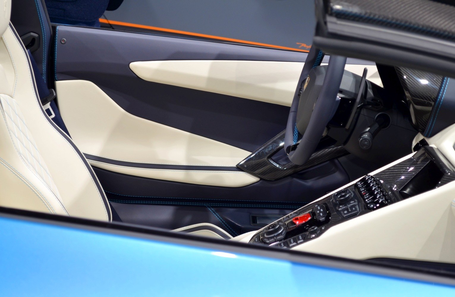 Luxury sports car interior with carbon fiber trim and advanced controls.