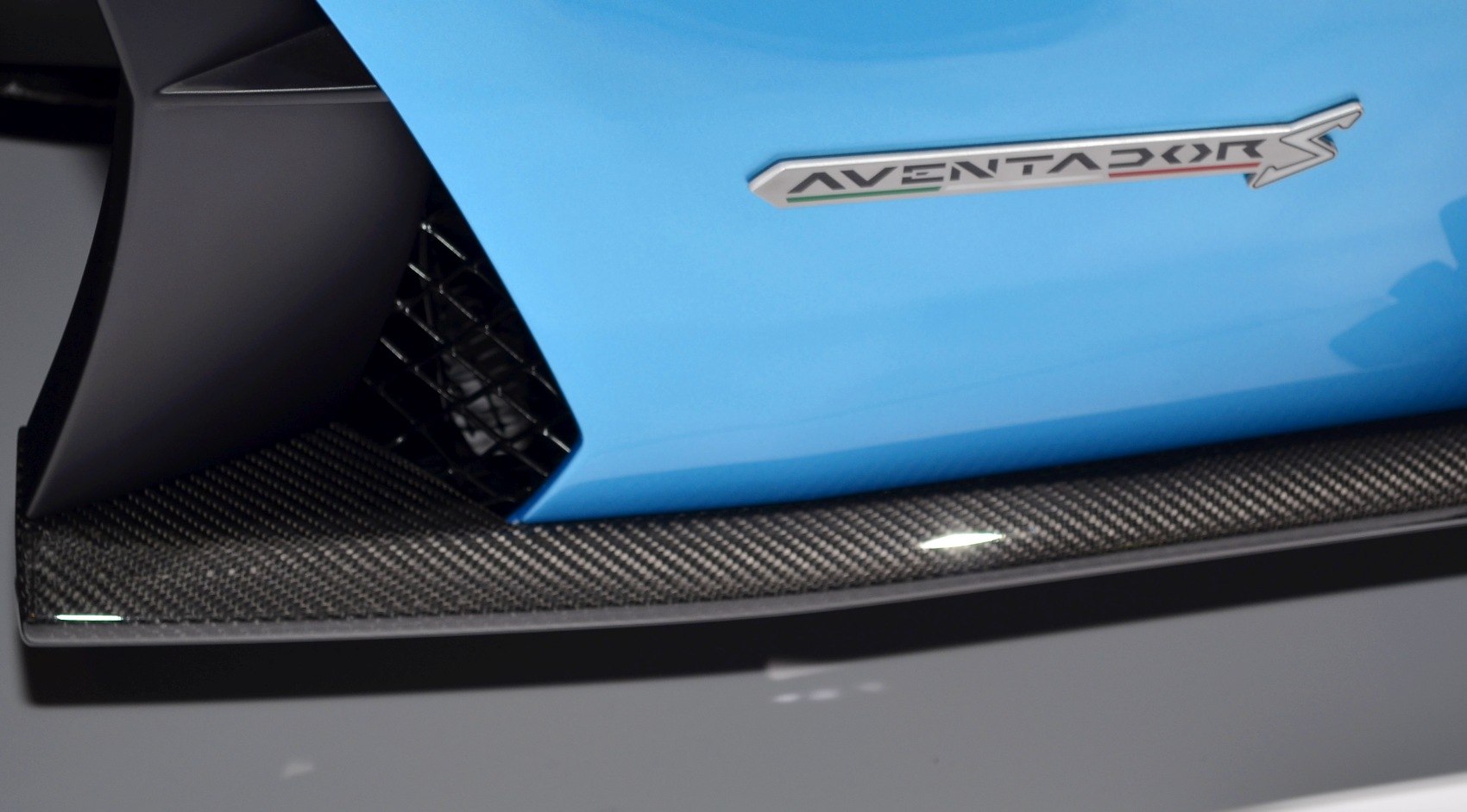 Close-up of side detail with AVENTADOR S badge and carbon fiber diffuser