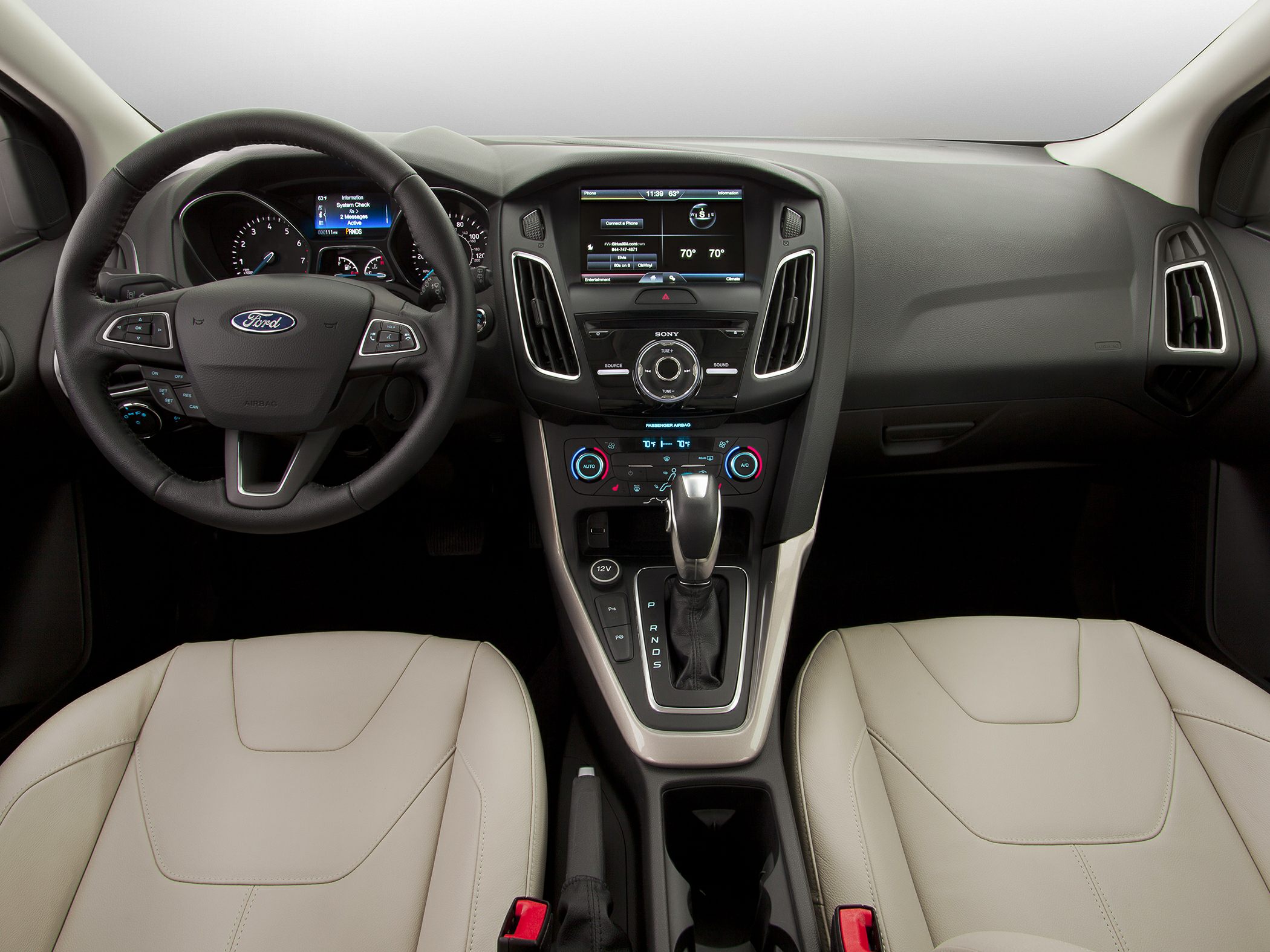 Dashboard, steering wheel, infotainment system, and gear shifter layout