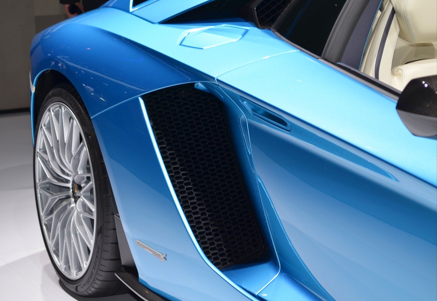 Blue side air intake vent and silver alloy wheel detail