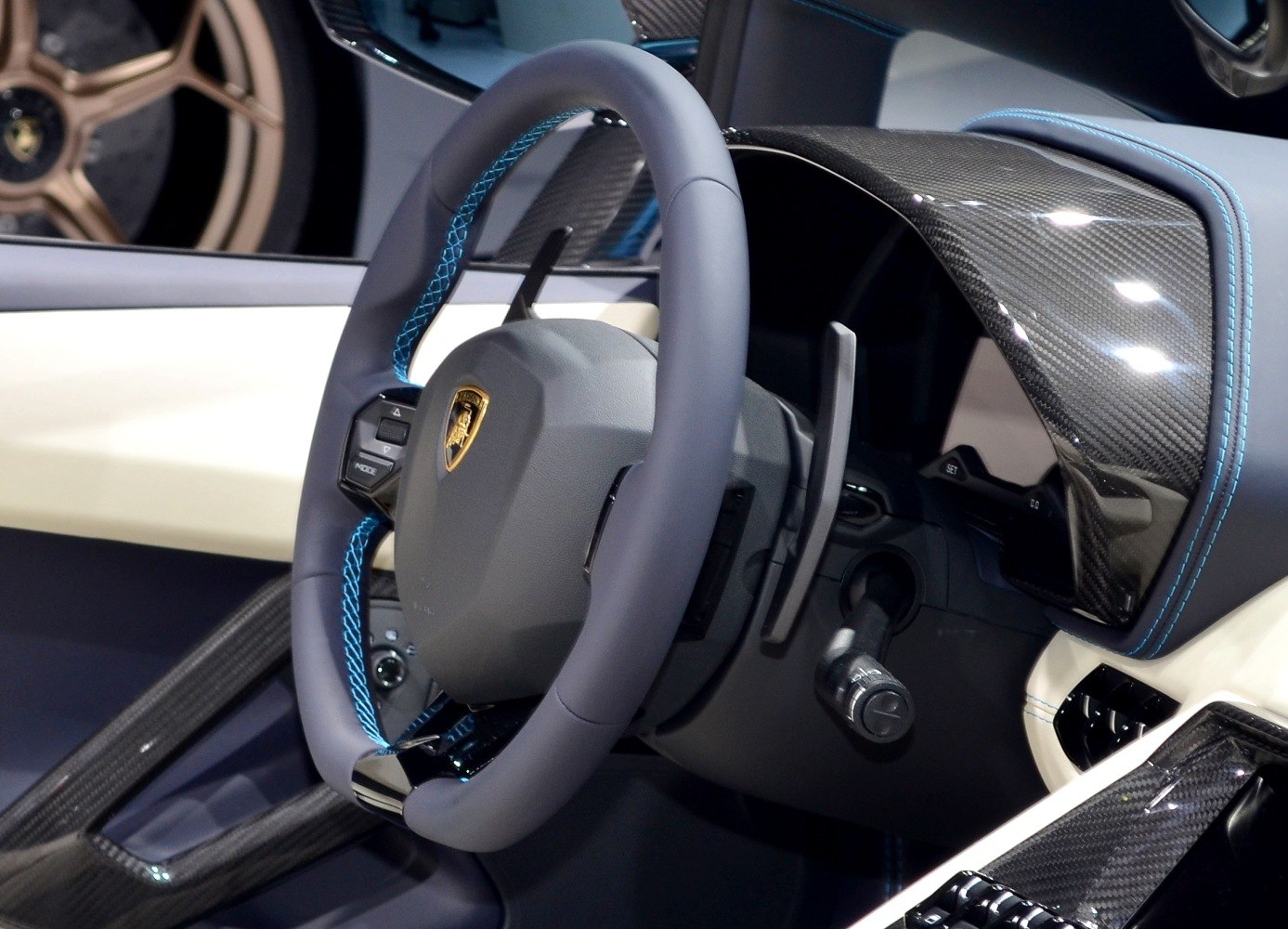 Steering wheel with blue stitching and carbon fiber dashboard interior