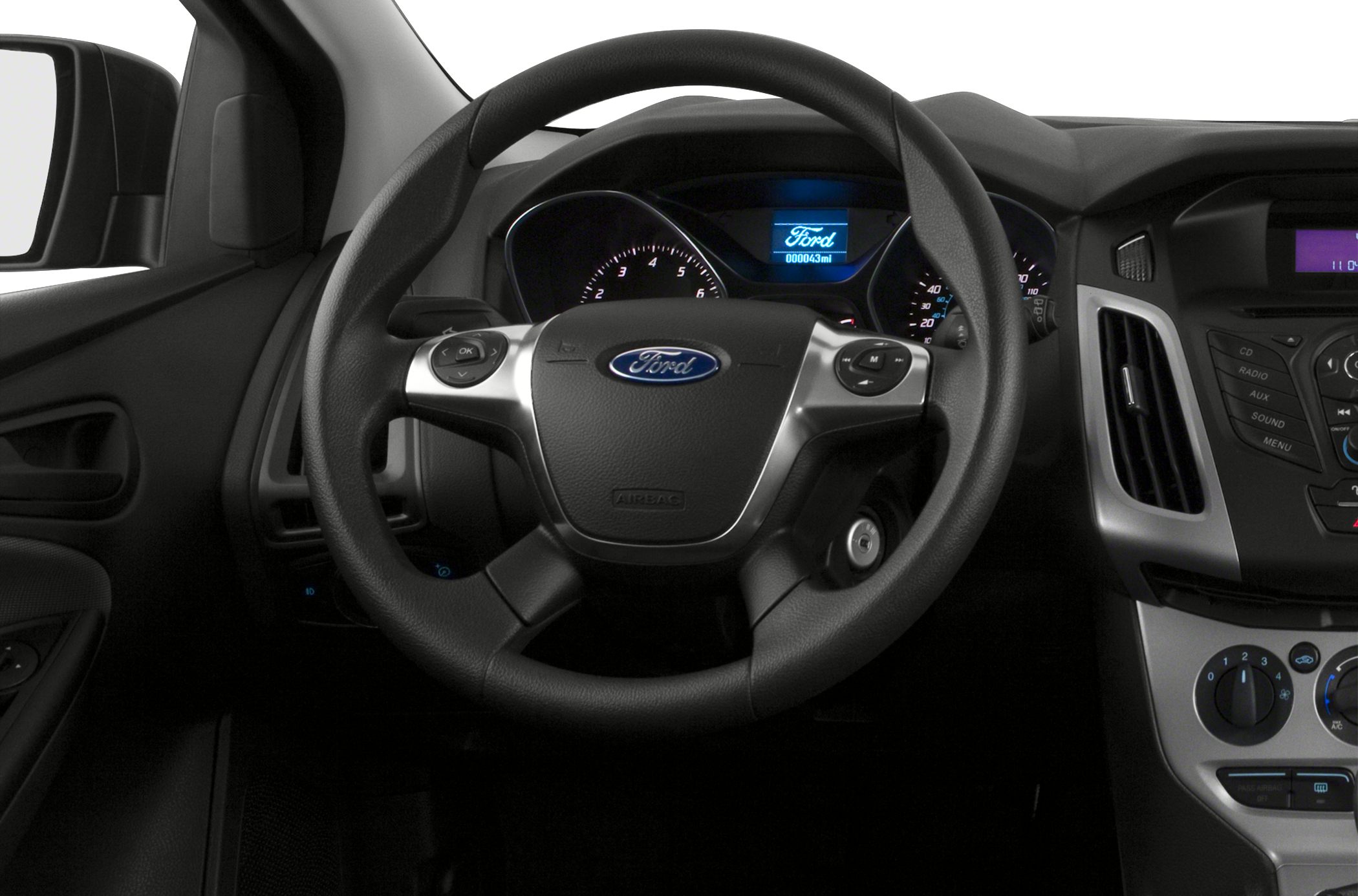 Steering wheel and dashboard with instrument cluster and control buttons.