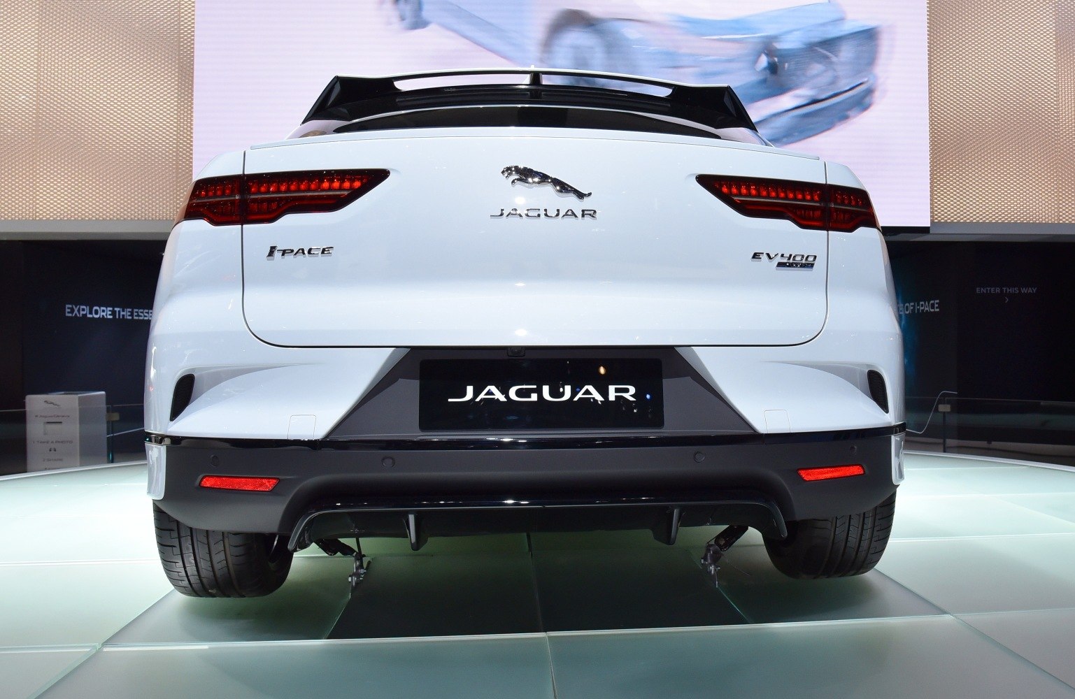 Rear view of electric SUV with sleek taillights and rear diffuser
