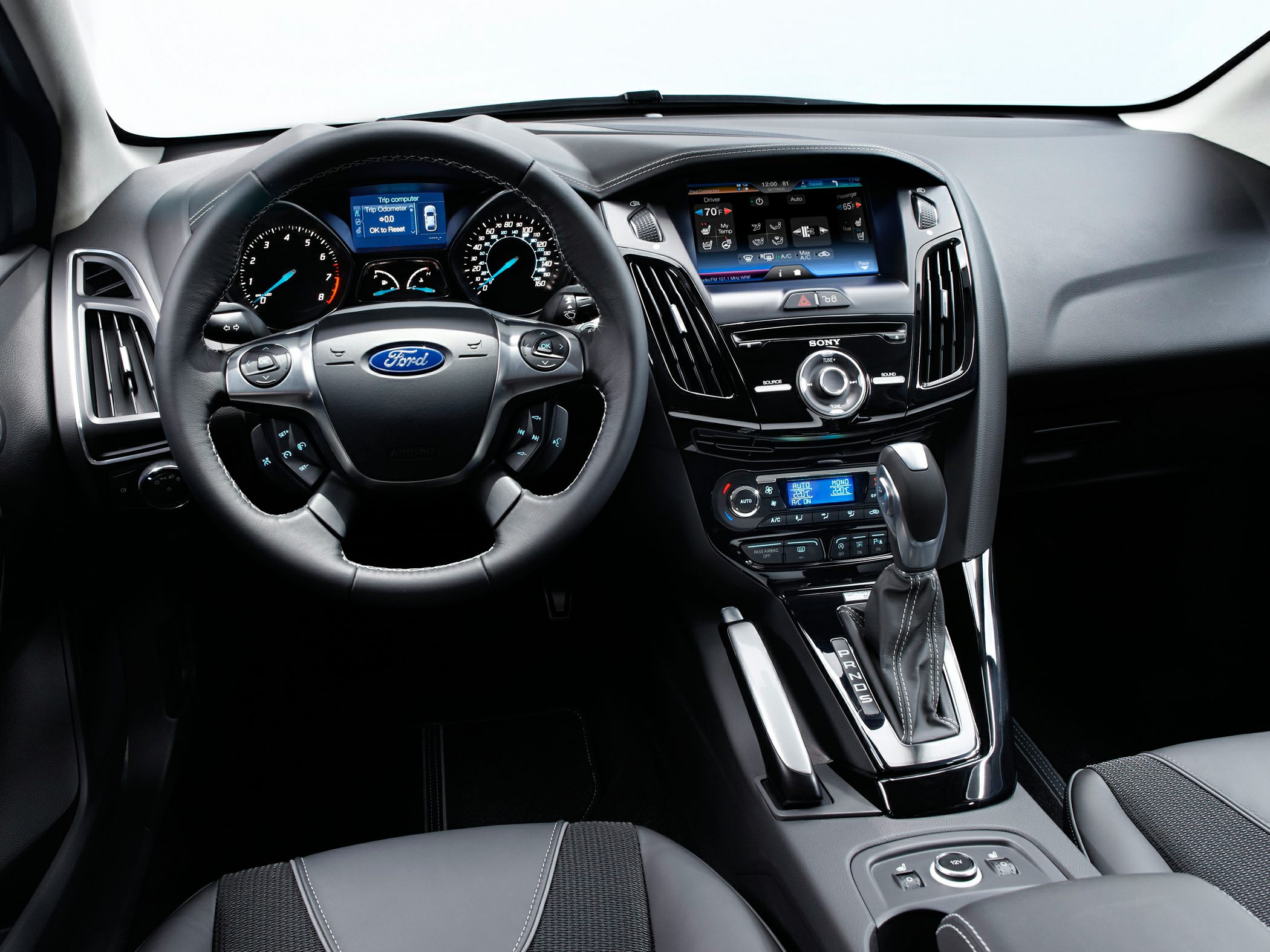 Modern steering wheel and dashboard with touchscreen and gear shift