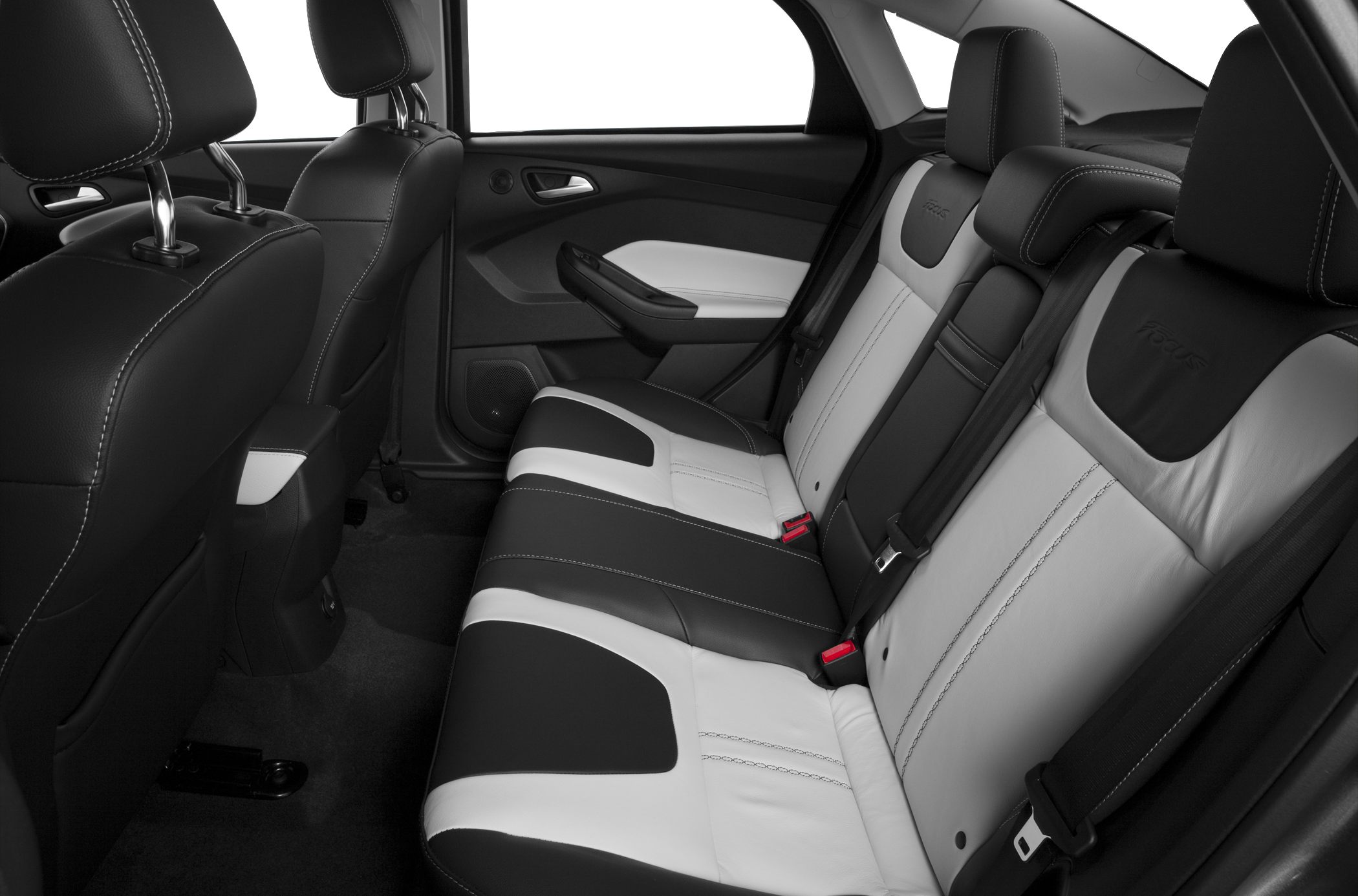 Rear seating area with black and white leather upholstery and detailed stitching