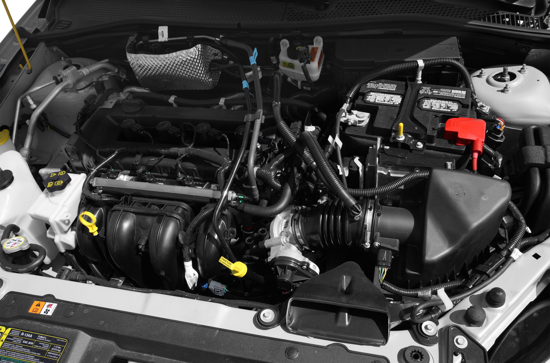 Engine bay with battery, air intake, and fluid reservoirs