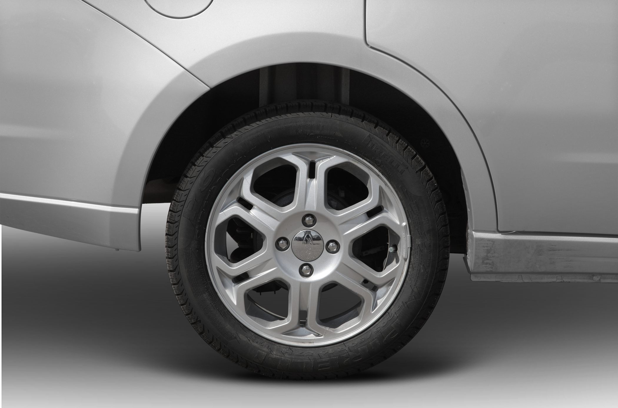 Close-up of alloy wheel and tire on rear side of sedan