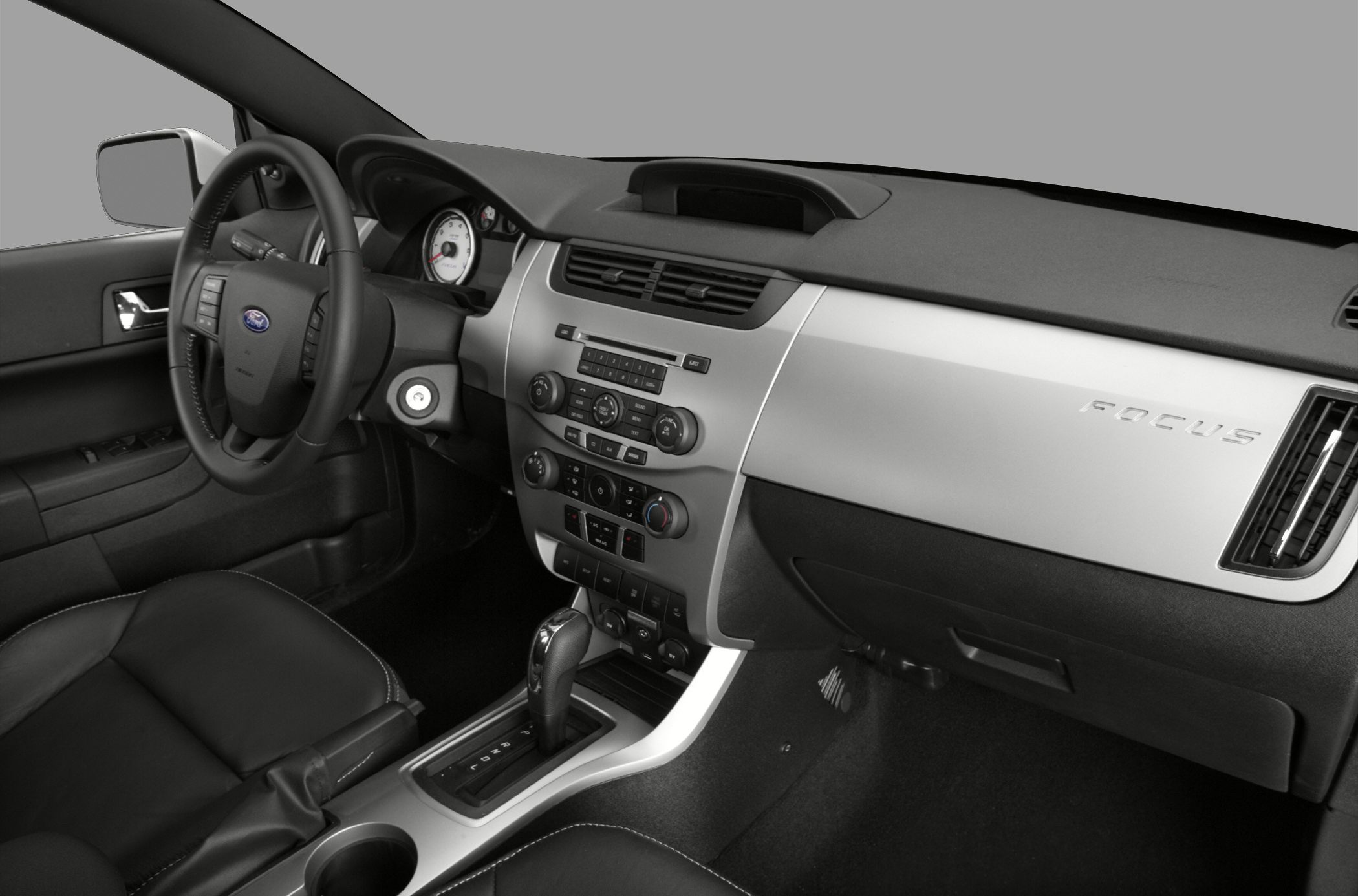 Interior dashboard, gear shift, and driver controls with leather seats