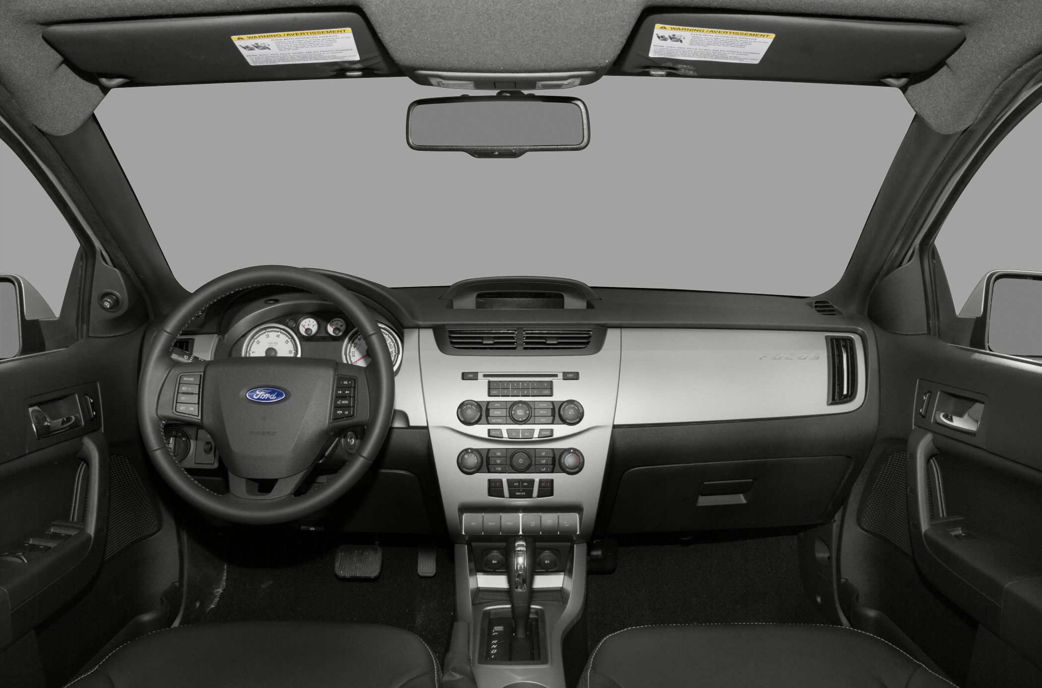 Dashboard and multifunction steering wheel in a mid-2000s sedan interior