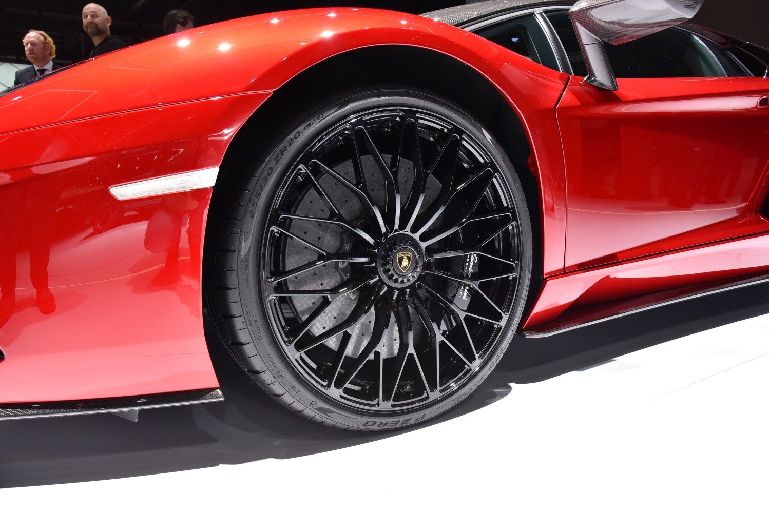 Close-up of black alloy wheel with high-performance tire and brake disc
