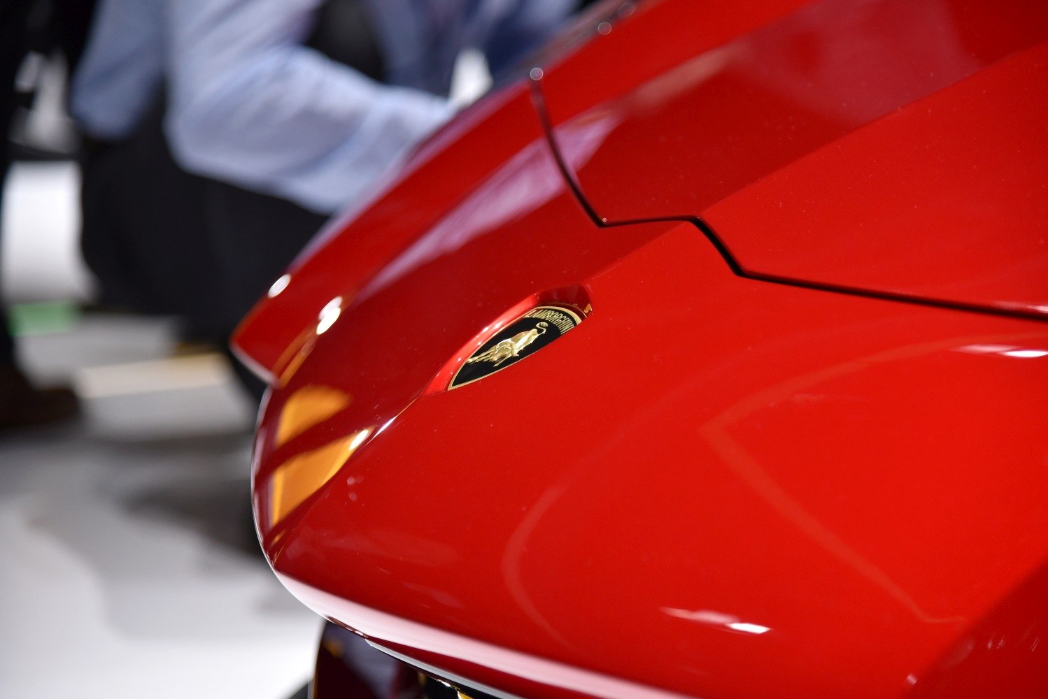 Sharp angular red hood with sports car emblem.