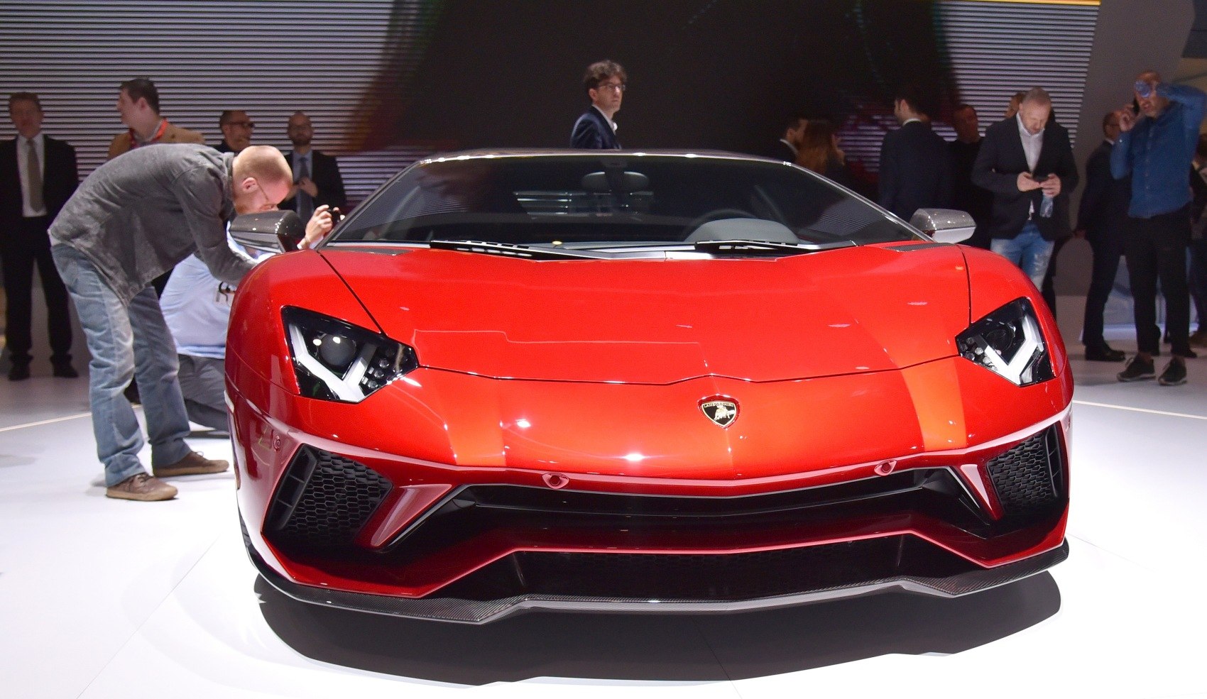 Front view of red supercar with sharp headlights and aerodynamic design