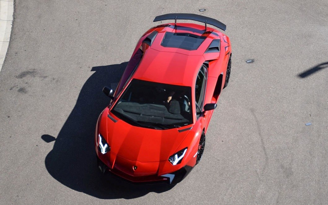 Red sports car with angular LED headlights and rear spoiler
