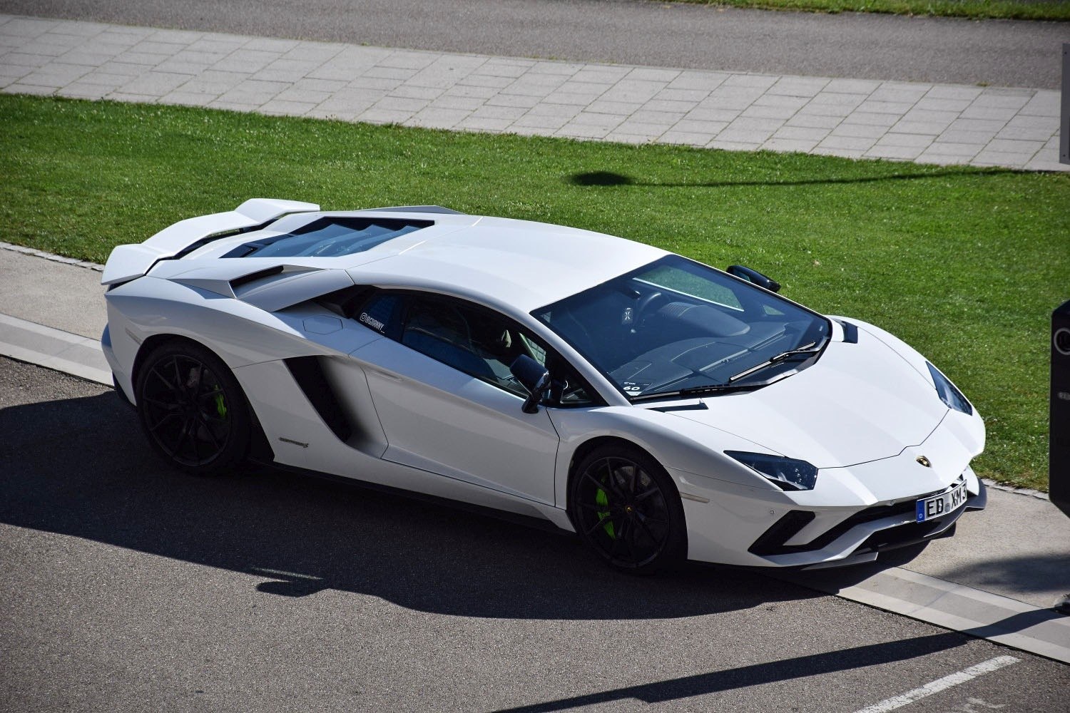 White Lamborghini with sharp aerodynamics and visible rear engine cover