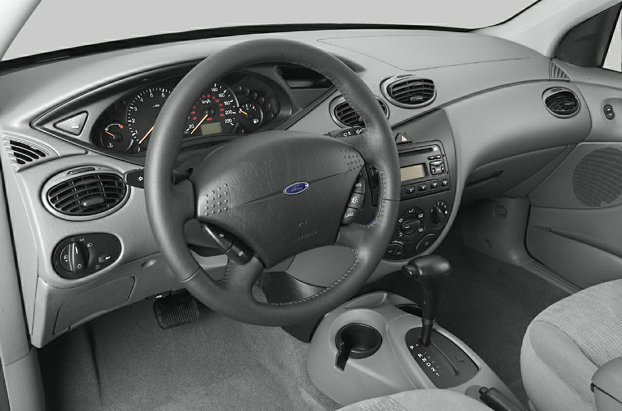 Dashboard, steering wheel, and automatic gear shifter inside a sedan