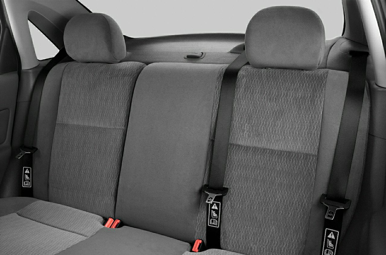 Rear seat upholstery with headrests and seatbelts.