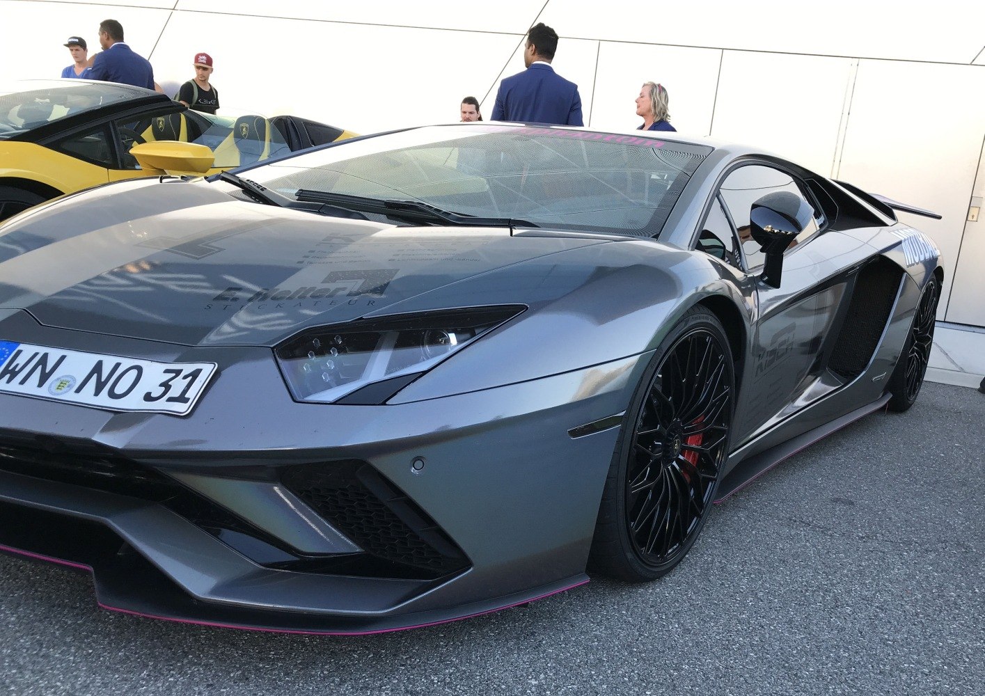 Aggressive front end with sharp headlights and sporty black wheels