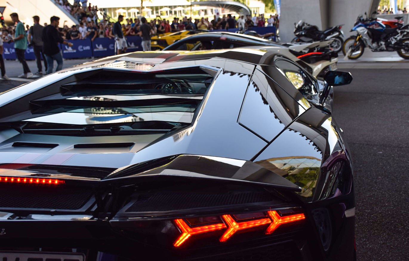 Rear LED taillights and glass engine cover with reflections.