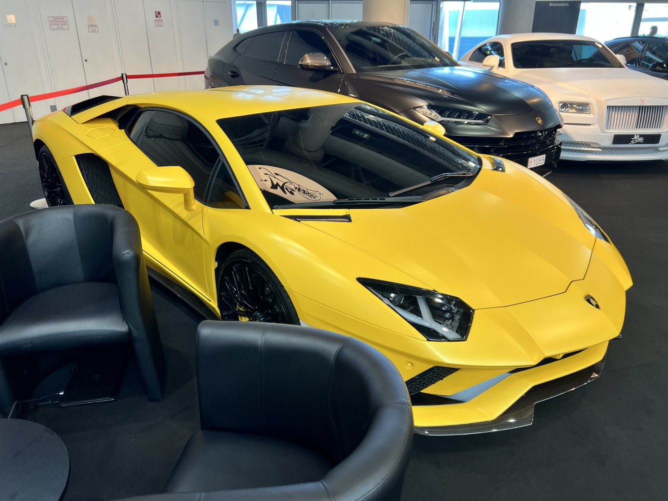 Low-slung yellow sports coupe with sharp angular headlights and aerodynamic front.