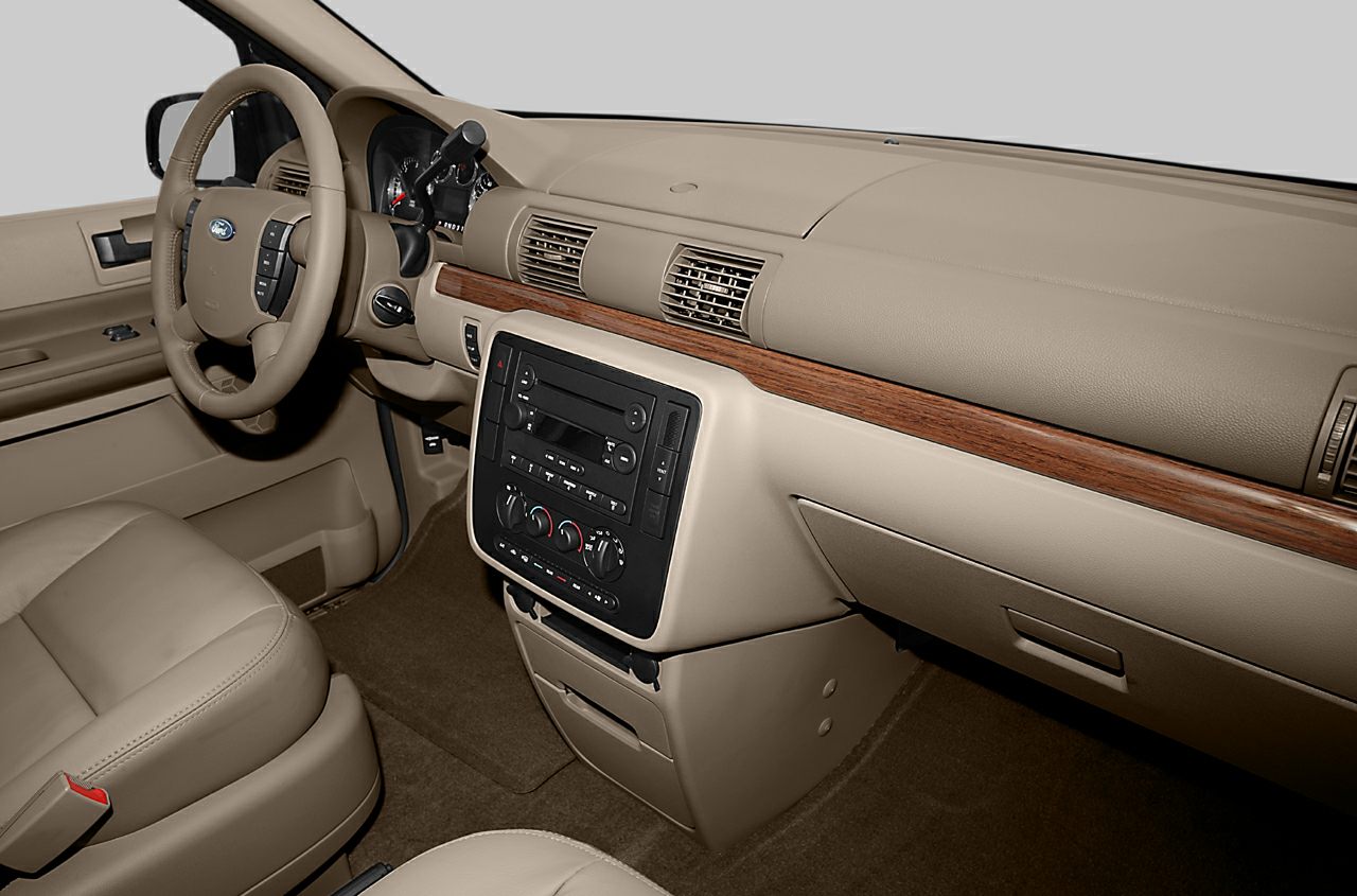 Beige dashboard with wood trim and steering wheel controls