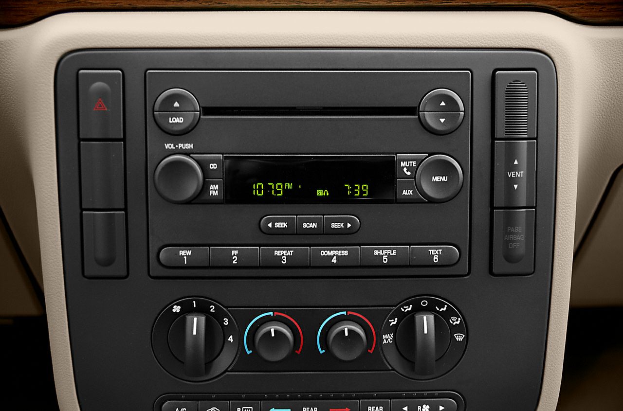 Car stereo and climate control knobs on dashboard console