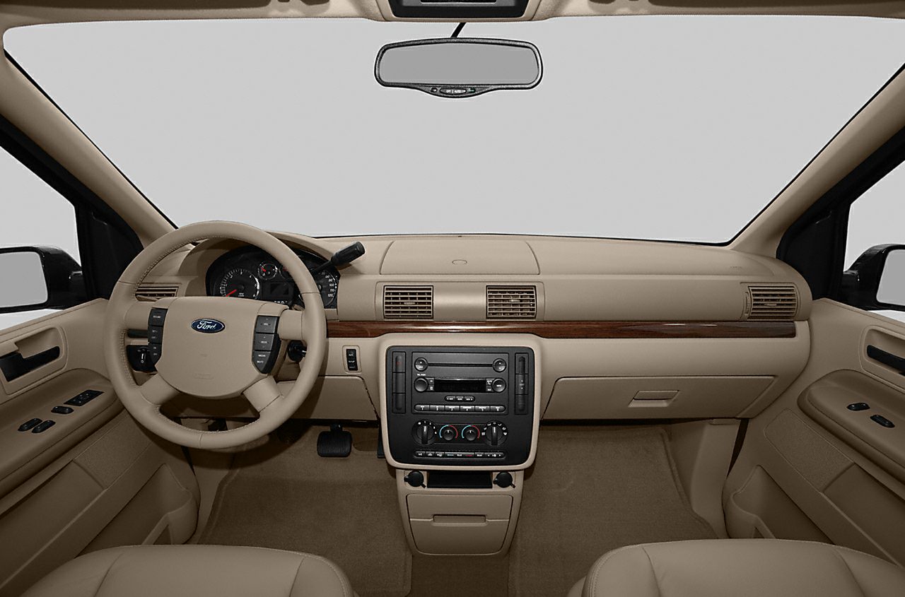 Beige interior dashboard with wood trim and steering wheel