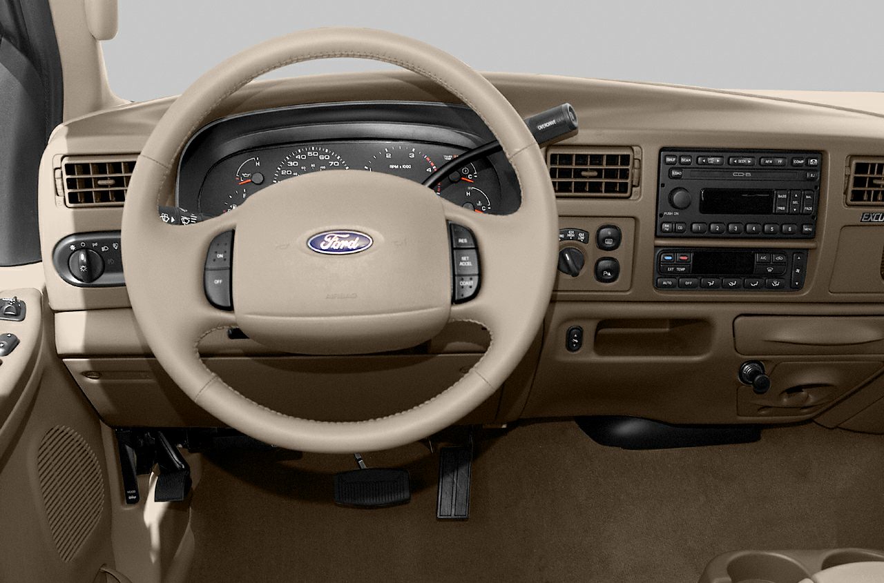 Beige dashboard with steering wheel and instrument panel