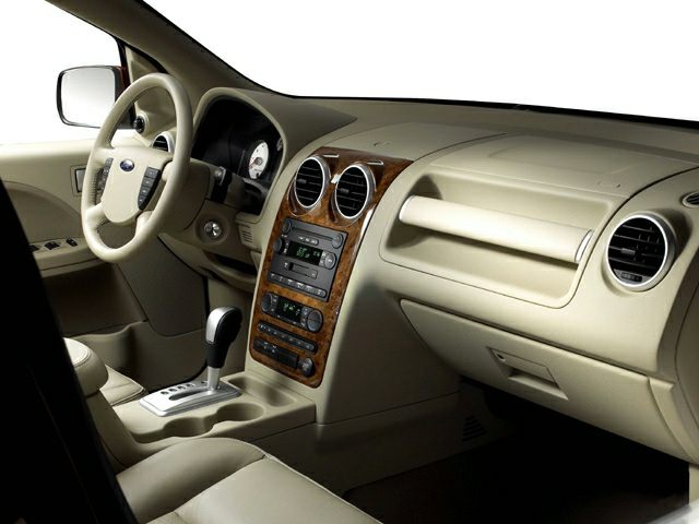 Beige dashboard with wood trim center console and automatic gear shifter