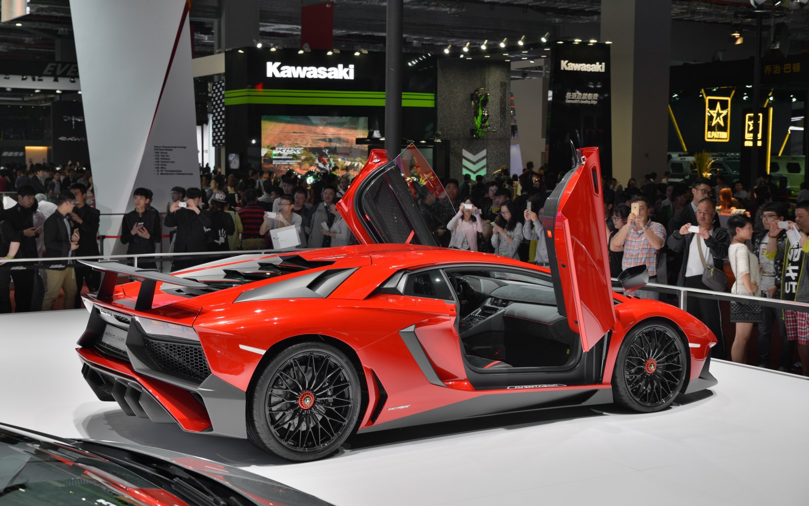 Sports car with scissor doors and rear wing spoiler