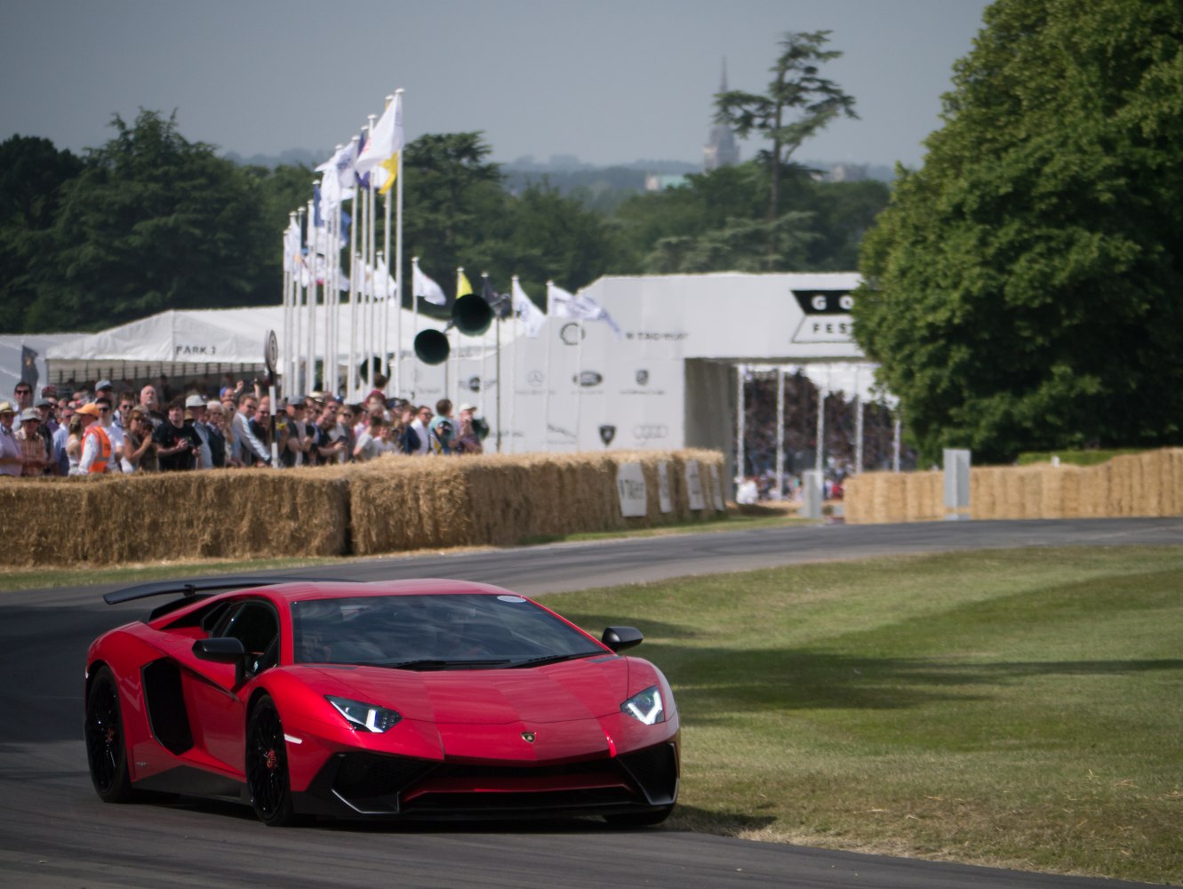 Red front view of aerodynamic super sports coupe on race track