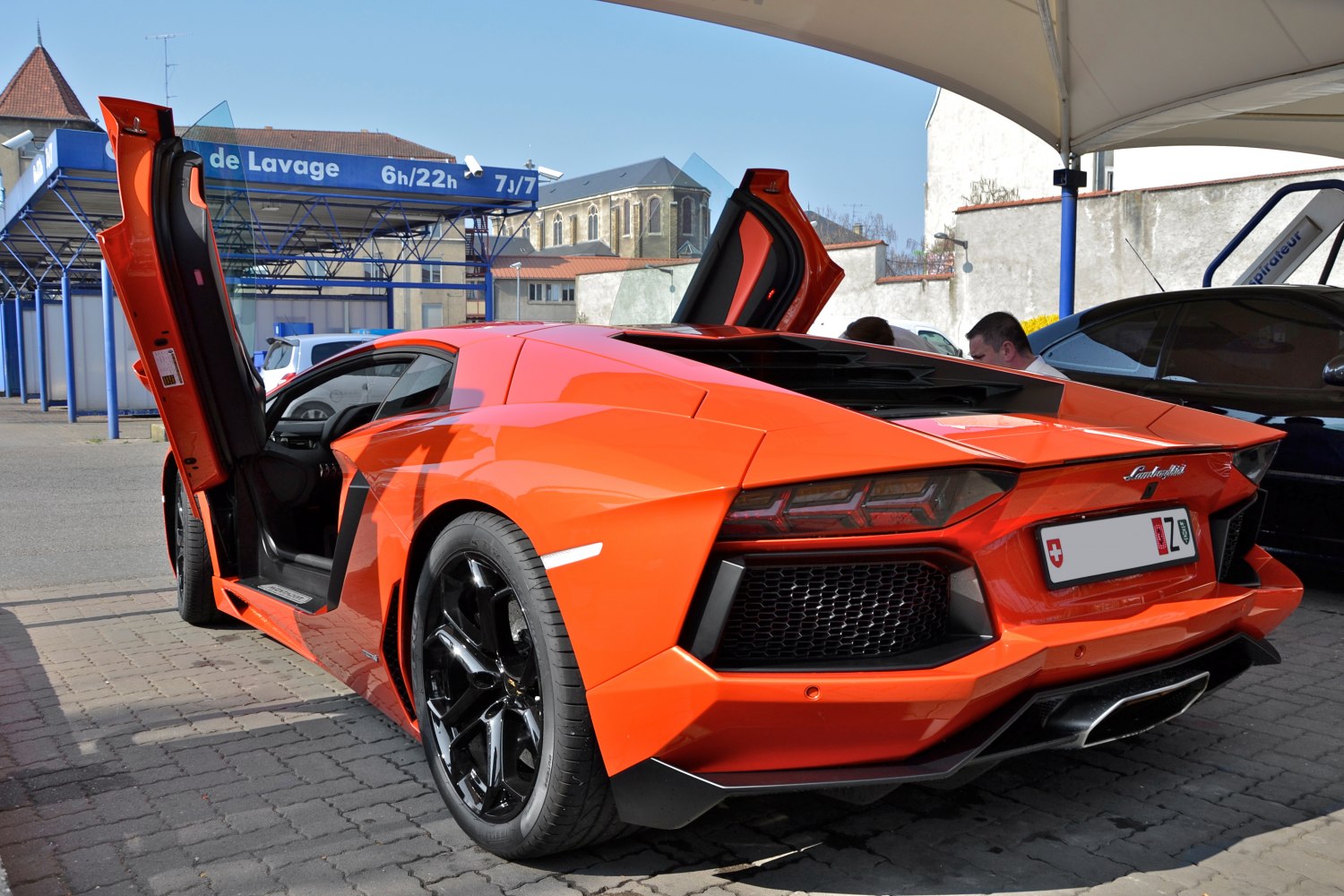 Scissor doors and aggressive rear design on a sports coupe