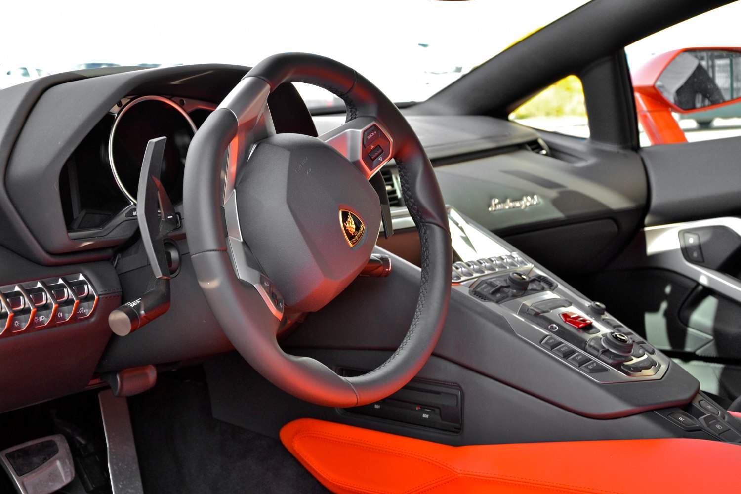 Luxury sports car interior with steering wheel and cockpit controls