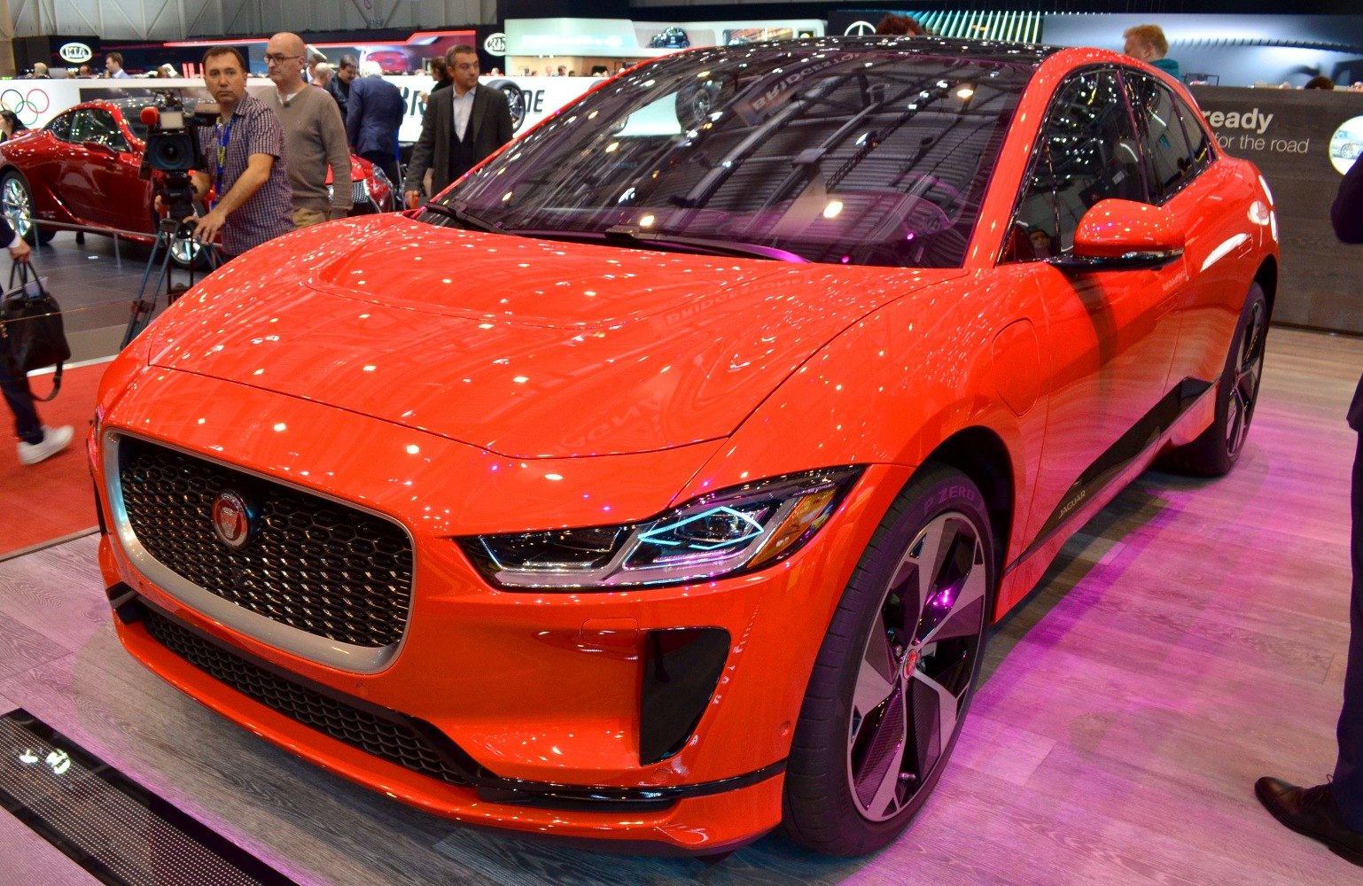 Red electric SUV front with LED headlights and detailed grille