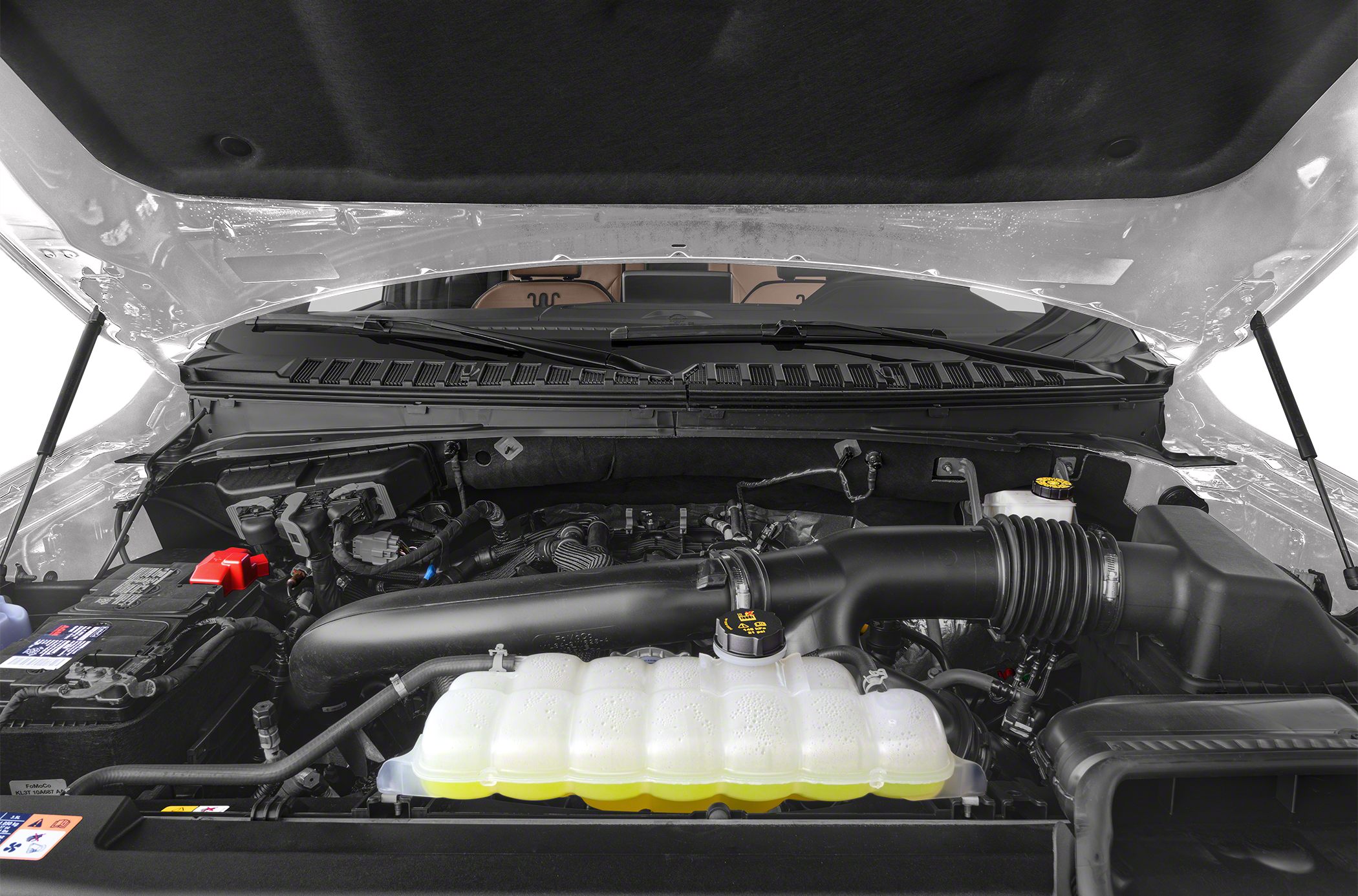Engine bay with air intake and coolant reservoir