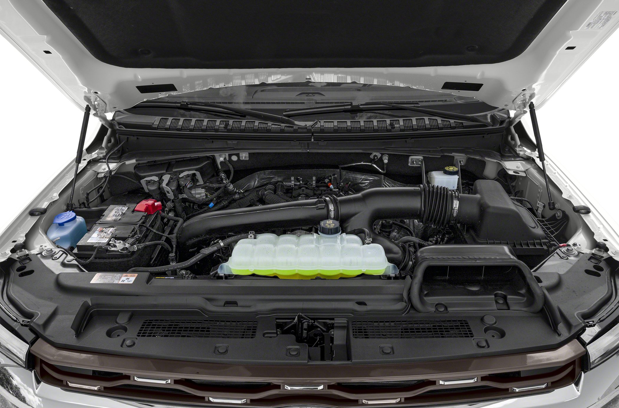 Engine compartment with battery, air intake, and coolant reservoir