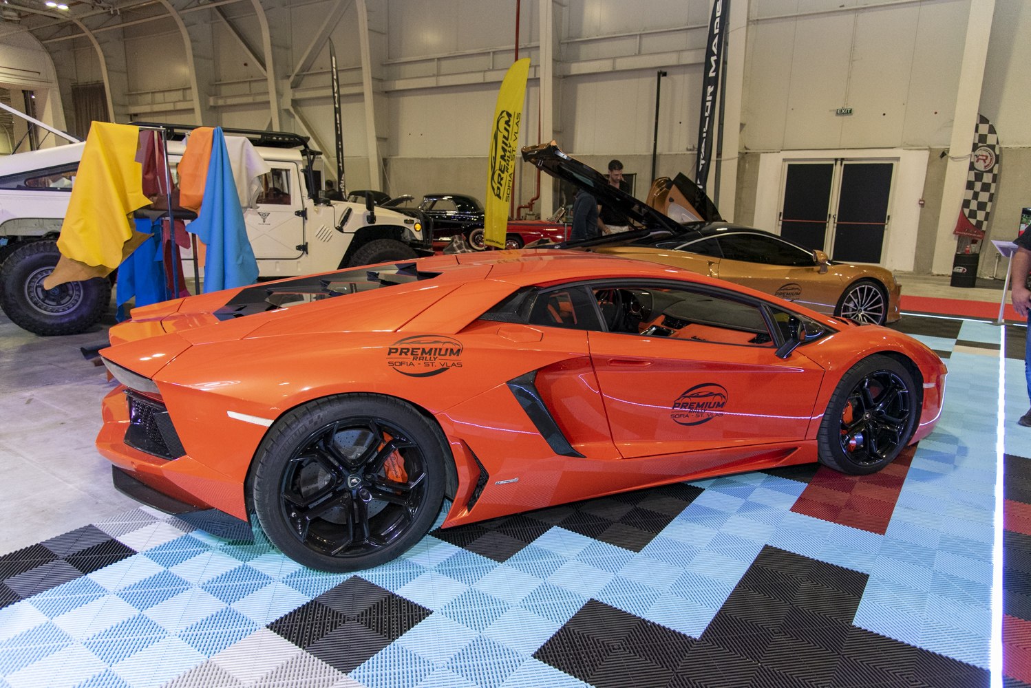 Orange sports car side profile with black rims and angular design