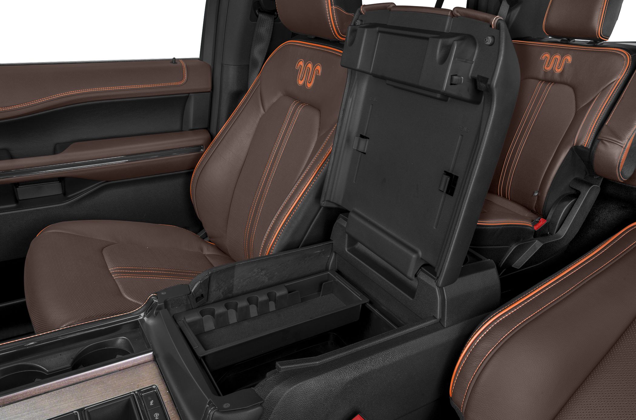 Brown leather seats with orange stitching and open center console compartment
