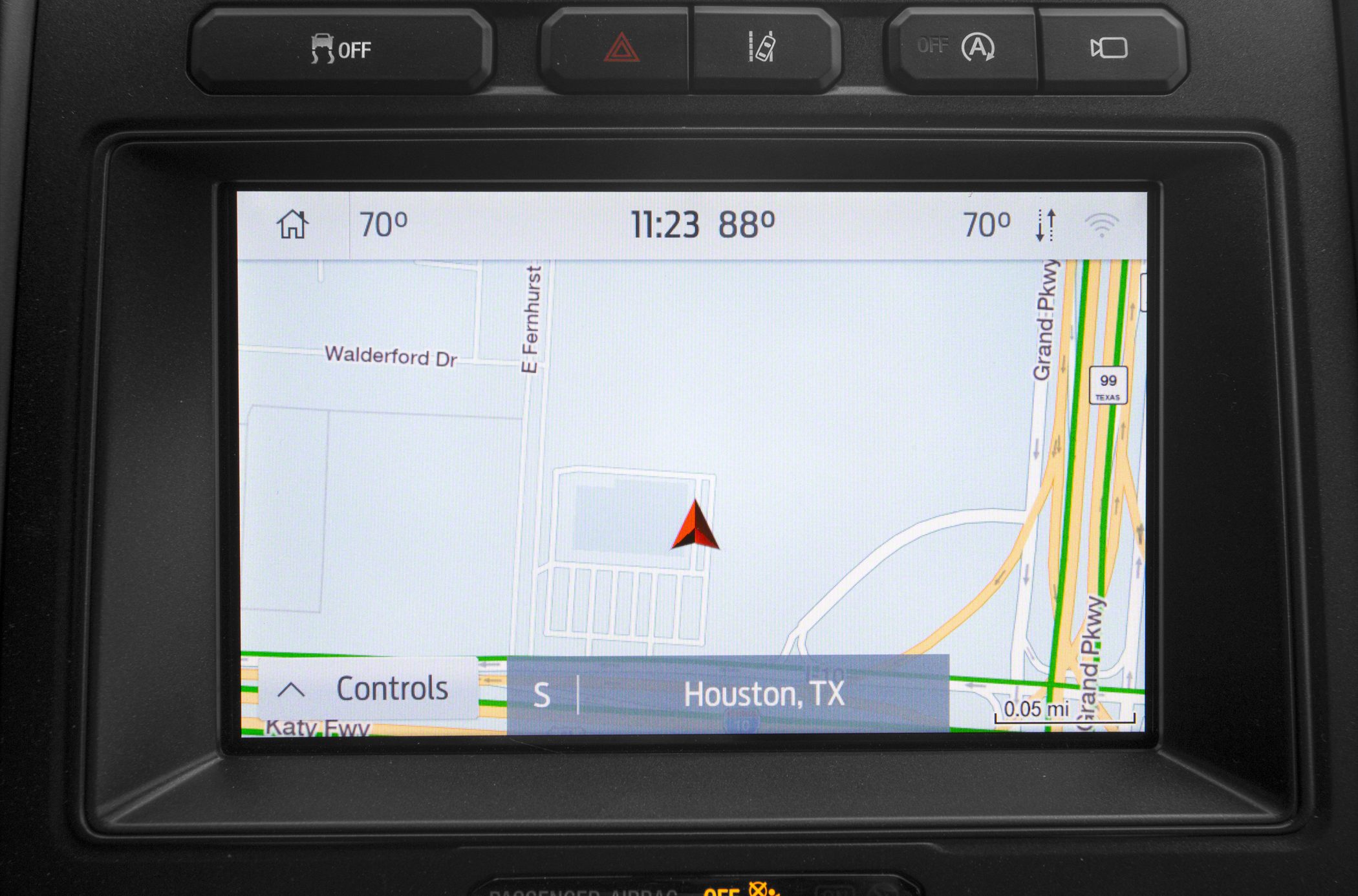 In-car GPS navigation touchscreen with map and location details.