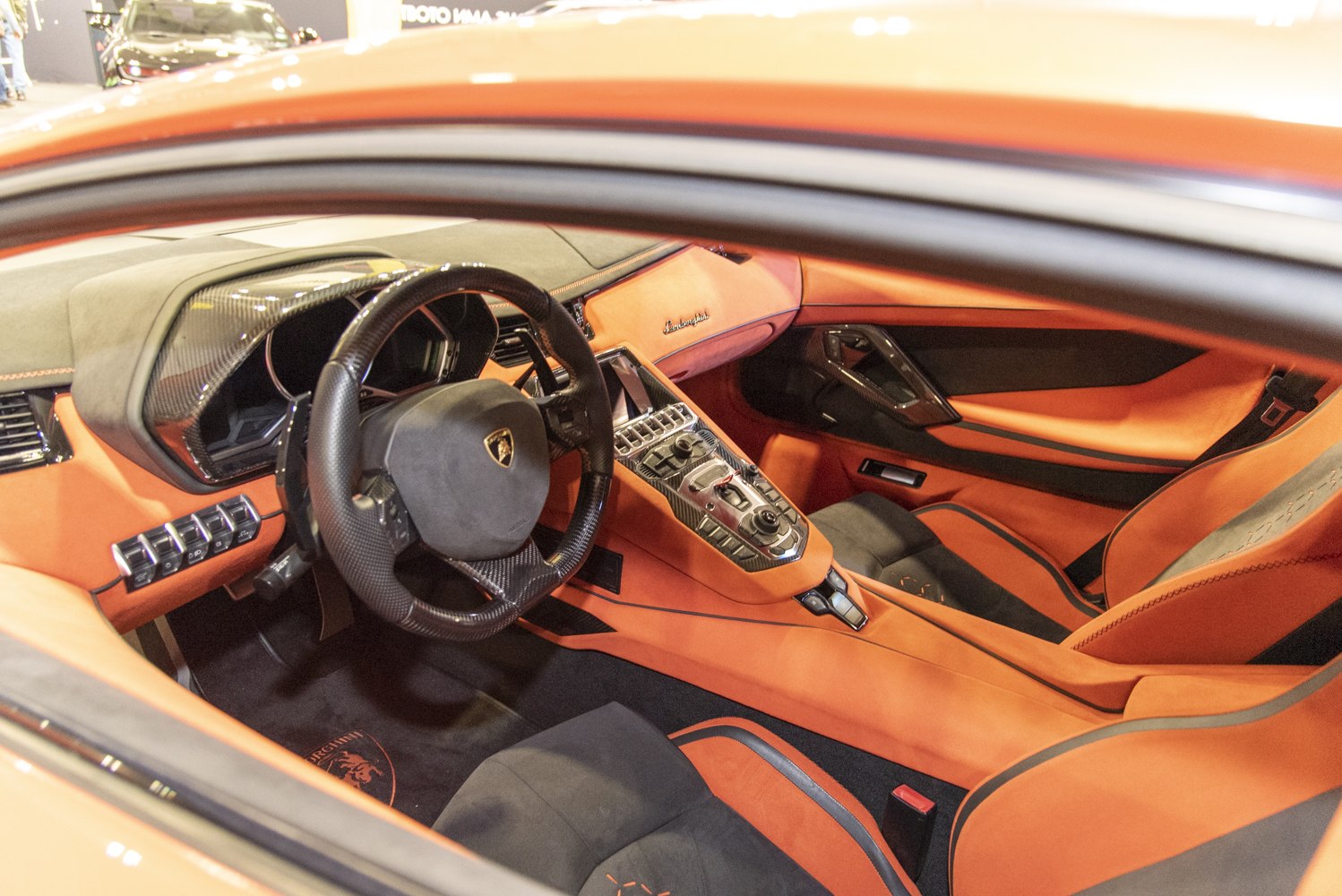 Luxury sports car interior with carbon fiber accents and premium seats