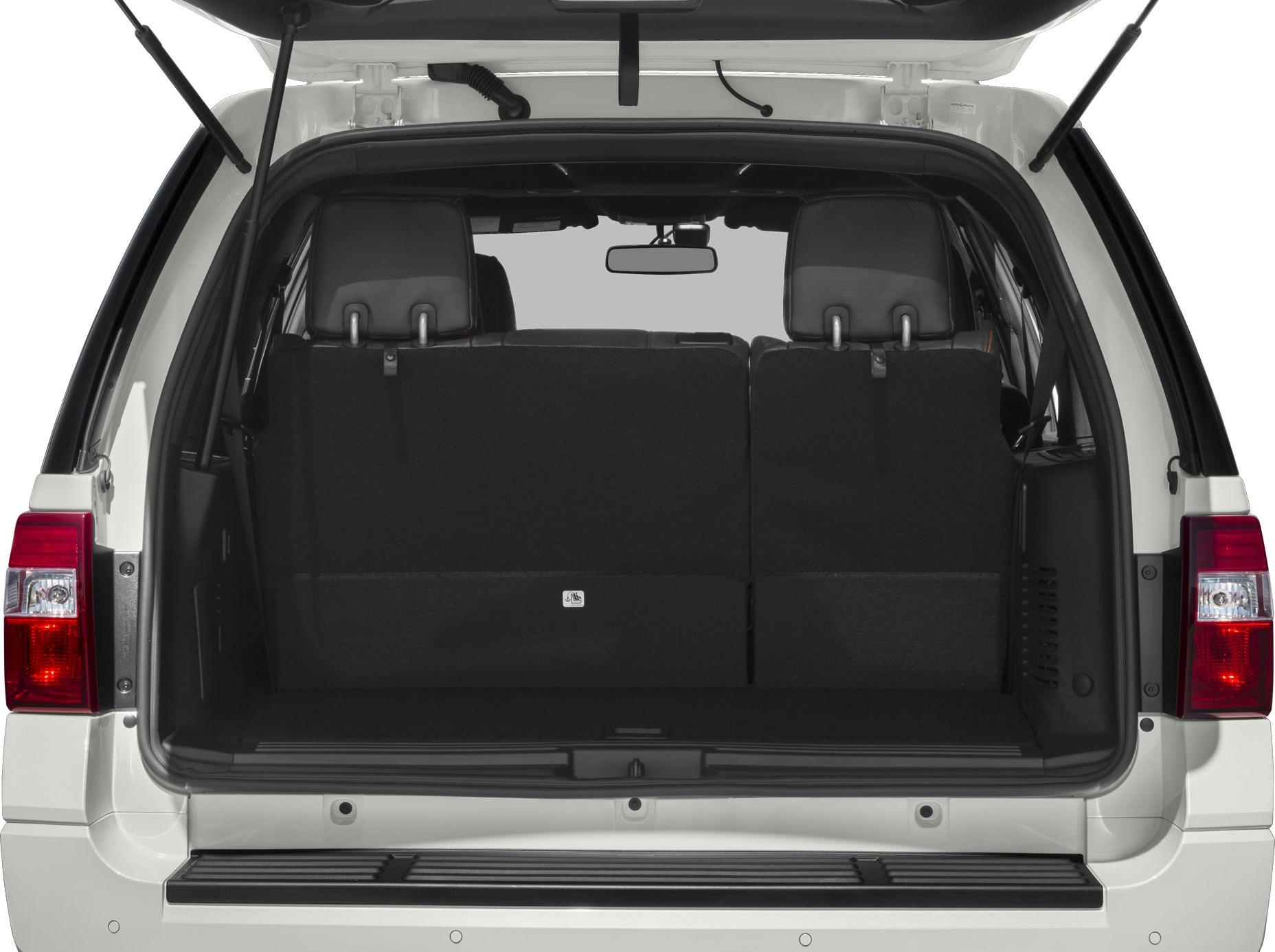 Open rear cargo space with black upholstery and tailgate.