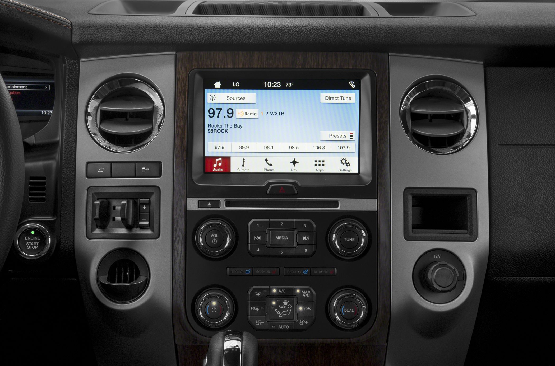 Central touchscreen infotainment and climate control panel with knob and button interface