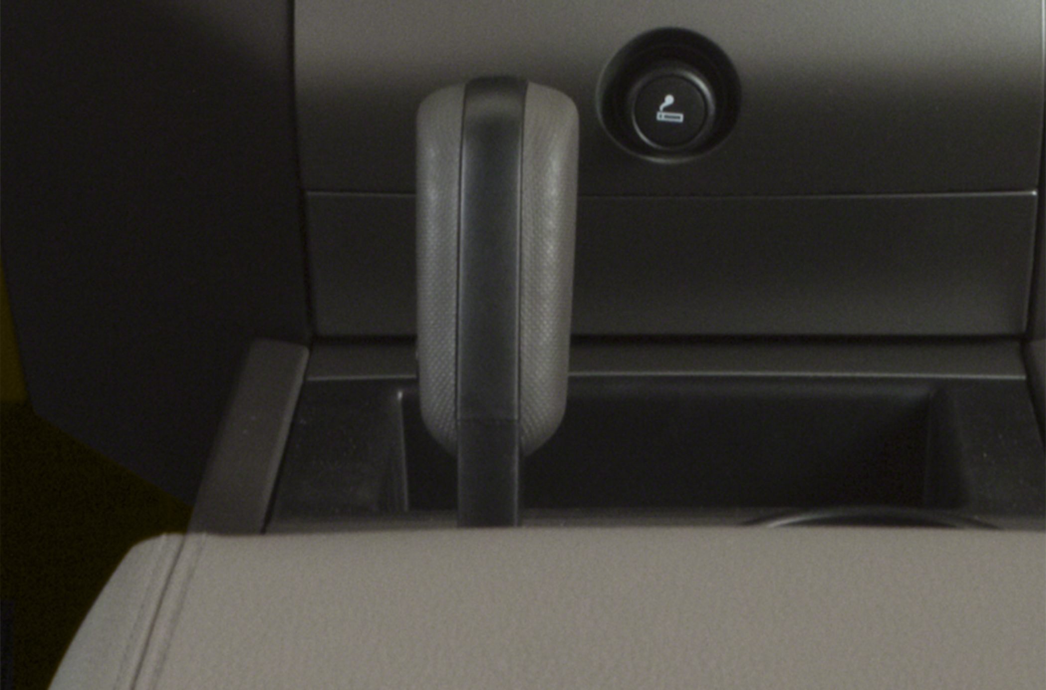 Close-up of gear shift lever and adjacent interior compartment