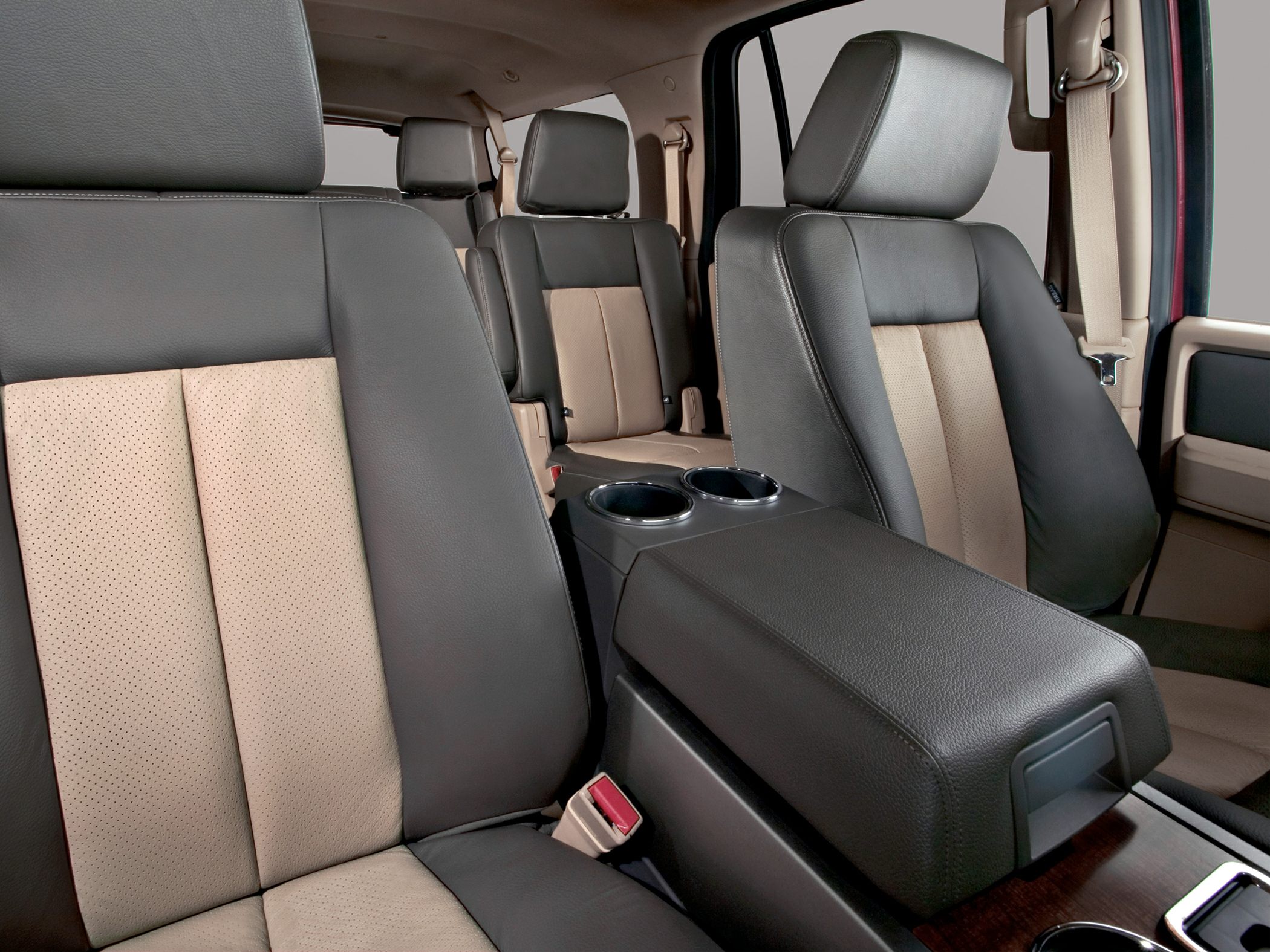 Two-tone leather seats and center console with cup holders in SUV interior
