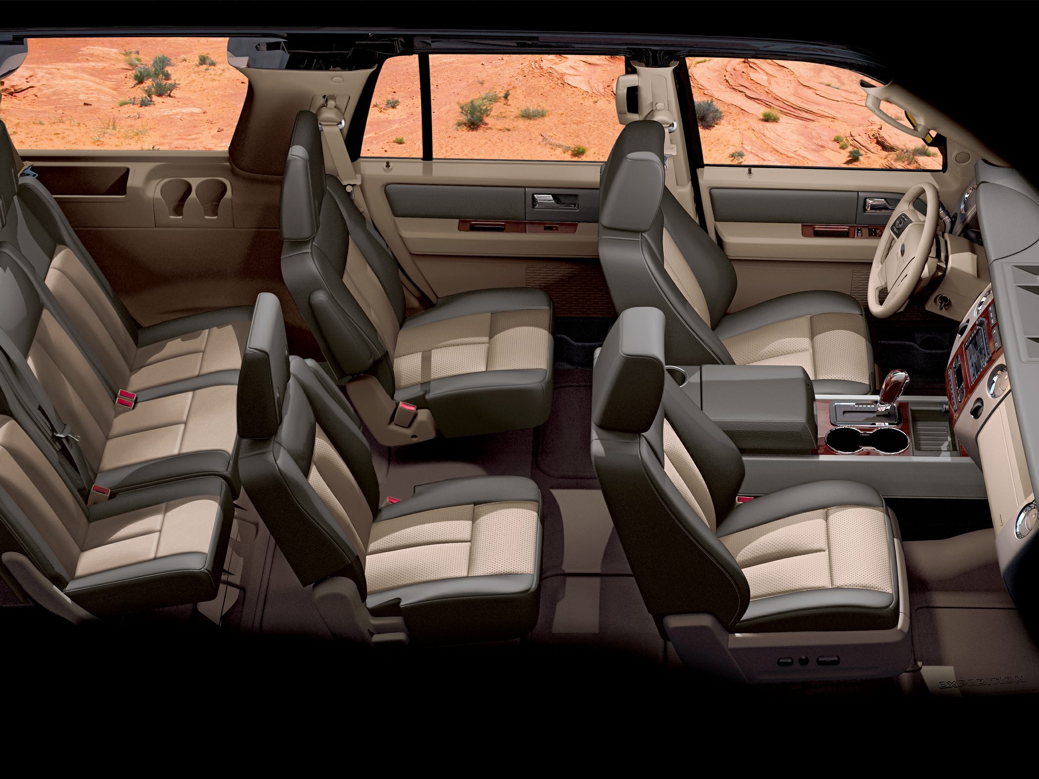 Spacious interior with three rows of beige and black seats.