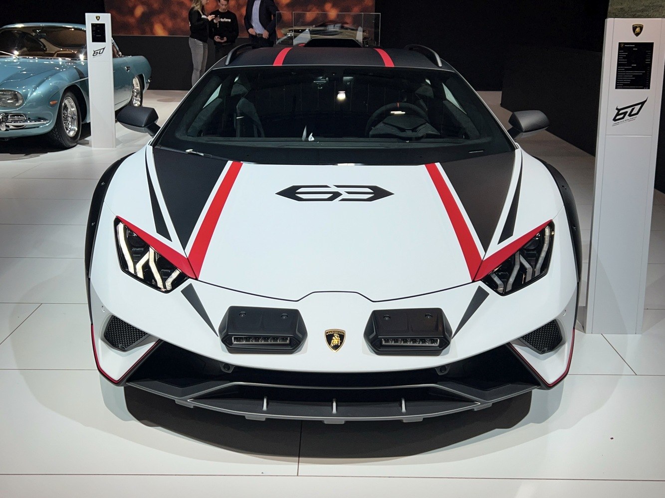 Aggressive headlights and distinctive hood graphics with red stripes on a sporty vehicle front.