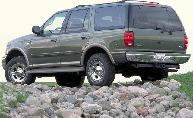 Rugged SUV rear side view on rocky terrain
