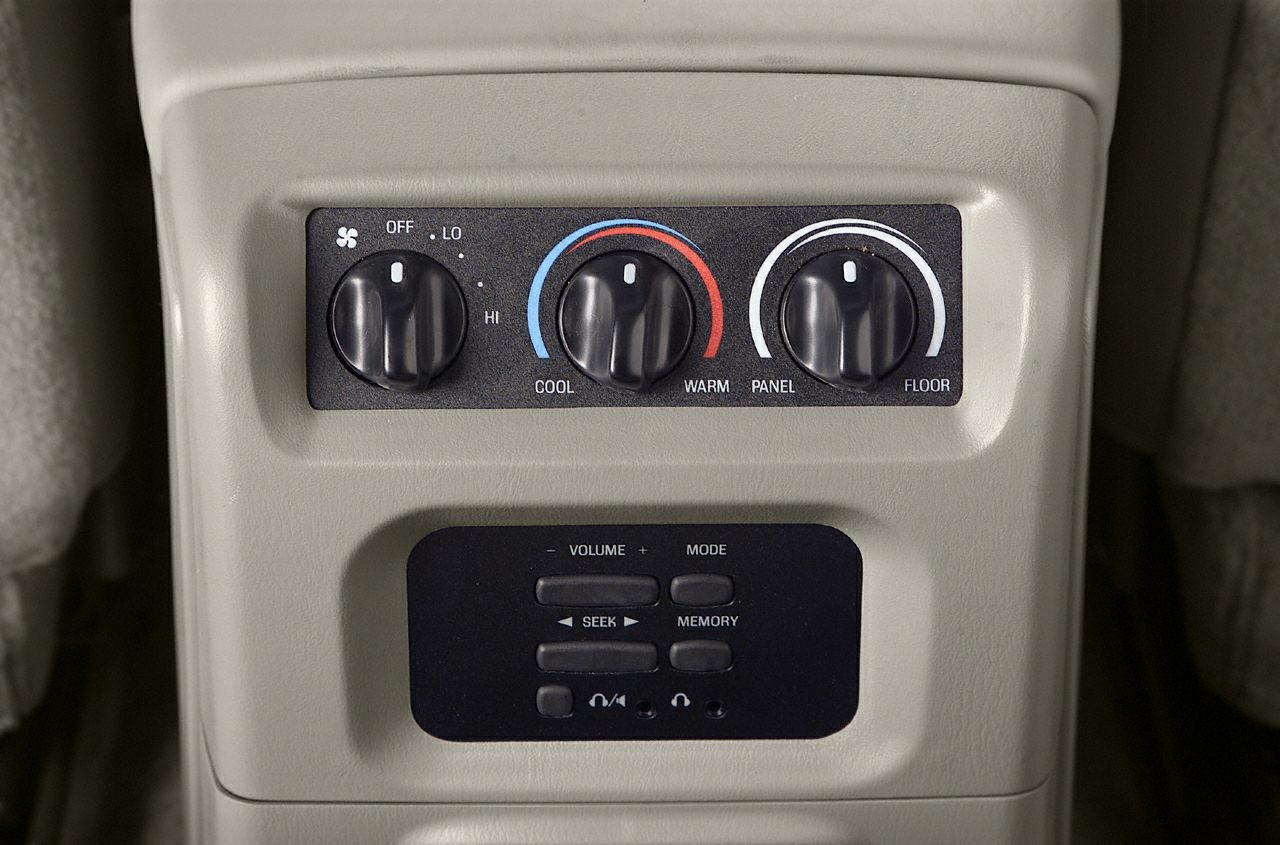 Rear climate and audio control panel with temperature and volume knobs