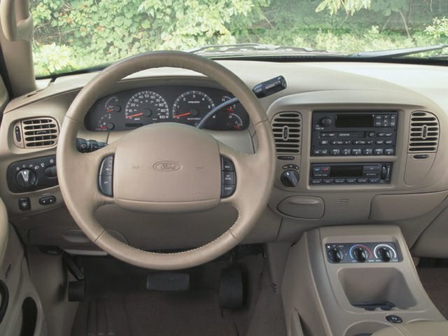 Dashboard, steering wheel, and control panel of 1990s SUV