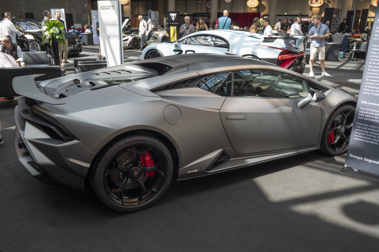 Matte gray supercar rear and side with aerodynamic features and black wheels